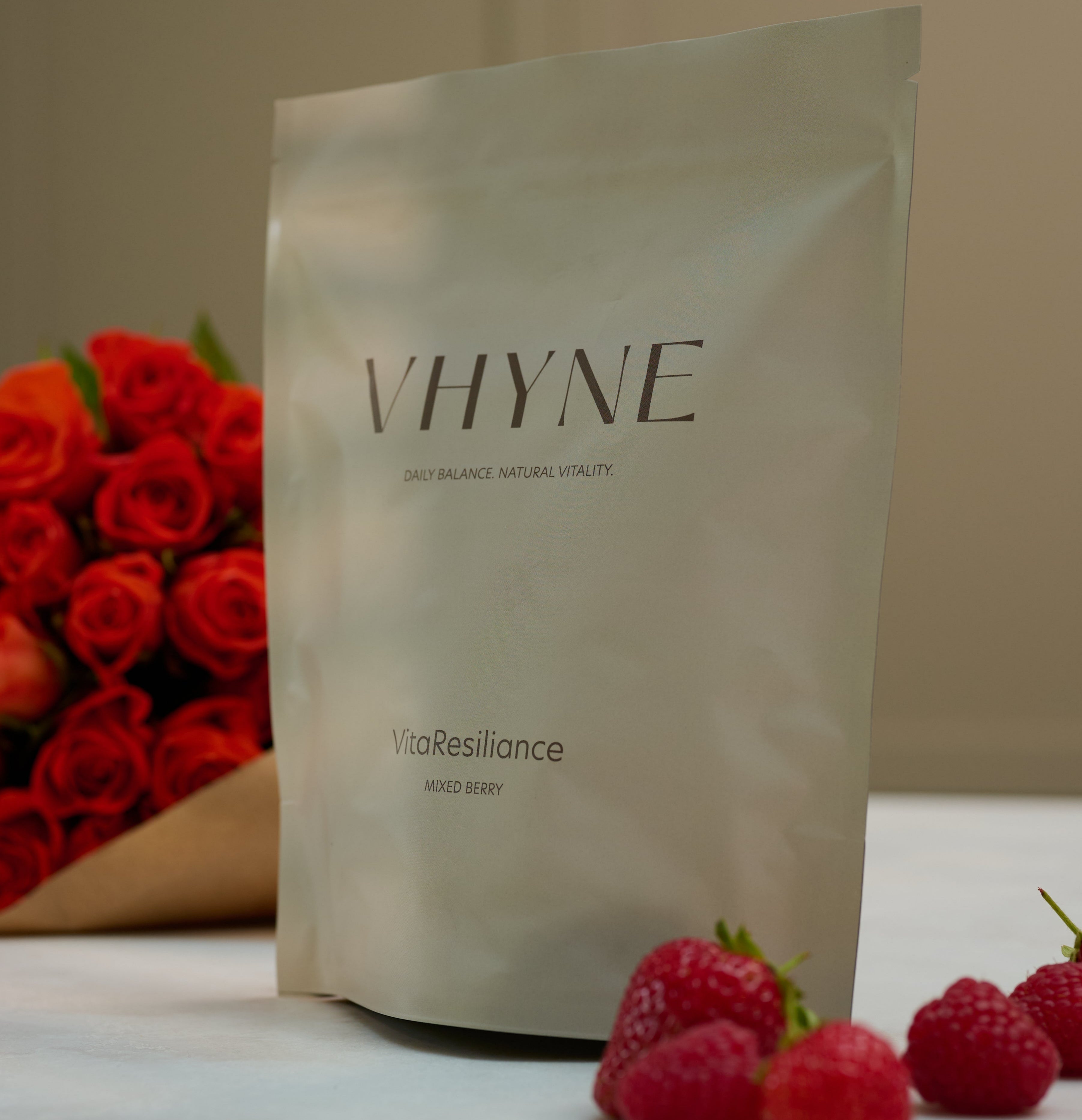Vhyne VitaResiliance pouch with raspberries, strawberries and roses on a neutral background